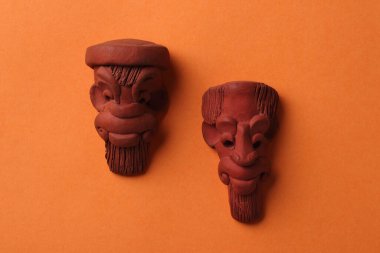 small clay artefacts on a deep yellow base