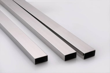 Stainless steel pipes on a white base.
