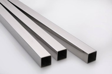 Stainless steel pipes on a white base.
