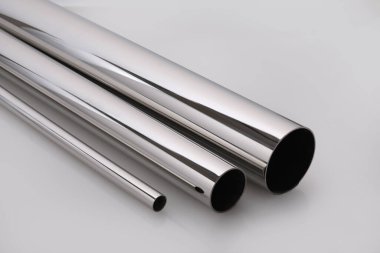 Stainless steel pipes on a white base.