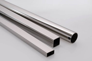 Stainless steel pipes on a white base.