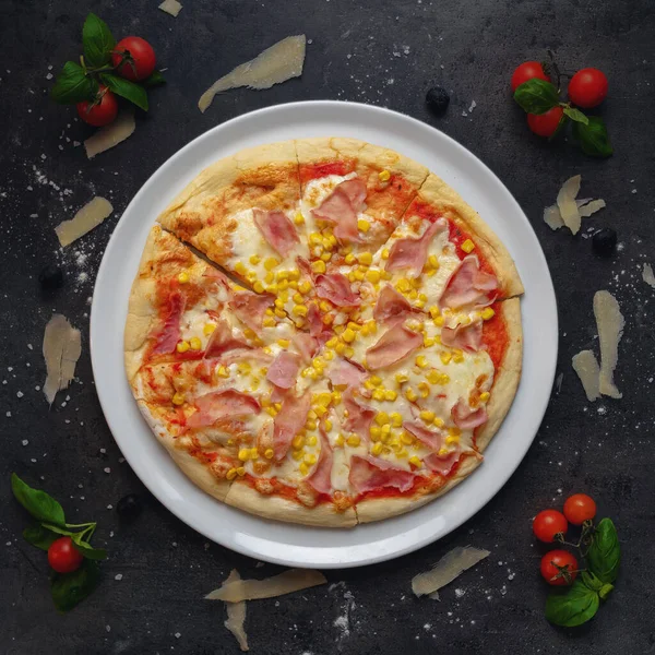 delicious pizza with ham, corn and cheese 