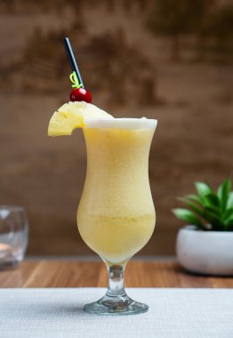 Pina Colada cocktail wth beautiful hotel background