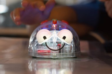 Kid testing his Robot in a Programing camp, smiling robot. High quality photo
