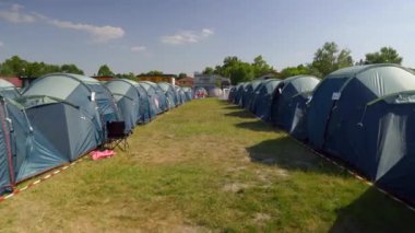 Parallel Blue tents Rows at the festival, summer light. High quality 4k footage