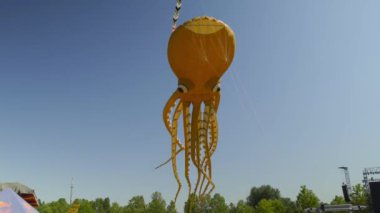 Huge Orange Flying Octopus at the Festival - kite. High quality 4k footage