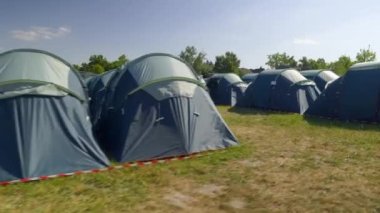 Parallel Blue tents Rows at the festival, summer light. High quality 4k footage