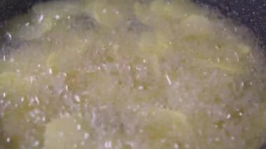 Frying chips in oil, sliced potato, clean, fresh oil. High quality 4k footage