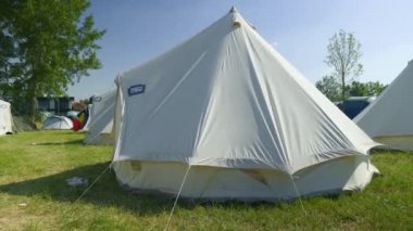 Bell Tents at the Festival Camping, Summer Light, trees in a background. High quality 4k footage