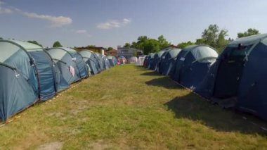 Parallel Blue tents Rows at the festival, summer light. High quality 4k footage