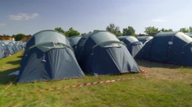 Parallel Blue tents Rows at the festival, summer light. High quality 4k footage