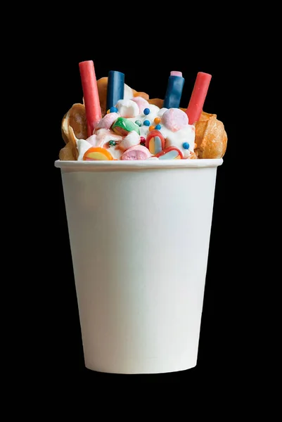 Bubble Waffle with gummy candy, Ice Cream, Candies And Whipped Cream in Cardboard Cup. . High quality photo