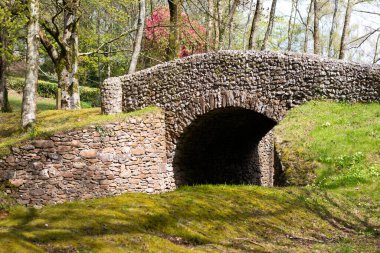 Old stone bridge in a rural landscape.