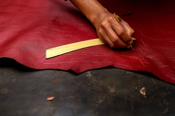 Magetan Leather Craft Workers. Portrait of a leather craftsman making sandals typical of Magetan, East Java - Indonesia.