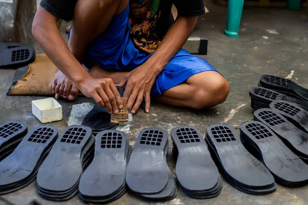 Magetan Leather Craft Workers. Portrait of a leather craftsman making sandals typical of Magetan, East Java - Indonesia.