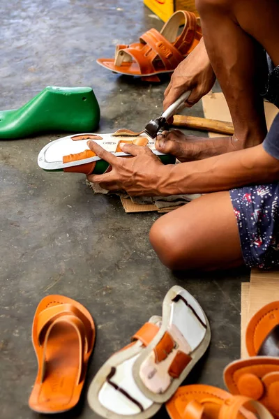 Magetan Leather Craft Workers. Portrait of a leather craftsman making sandals typical of Magetan, East Java - Indonesia.