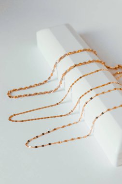 gold chain on a white box many chains