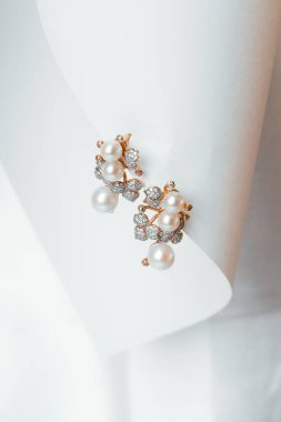 Gold jewelry with pearls on a white background , earrings 