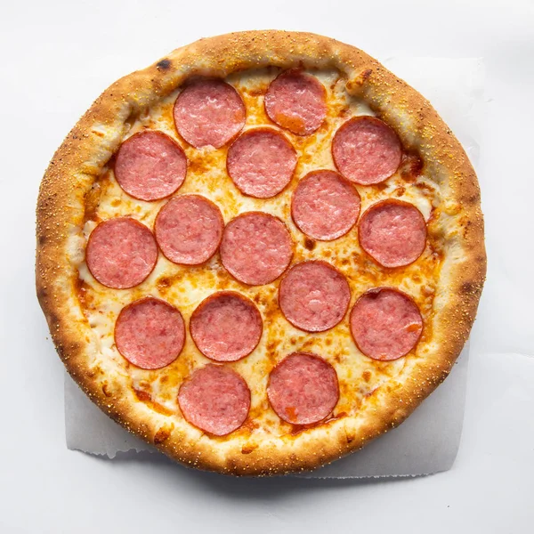 Pepperoni pizza with cheese side on a white plate with sausage