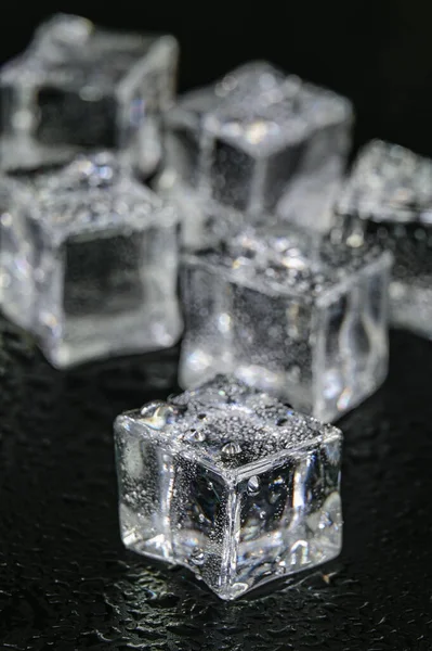 Multiple frozen ice cubes on a Black background