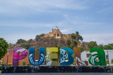 Colorful Sign for Puebla in front of the Giant Pyramid of Cholula and Santuario de la Virgen de los Remedios