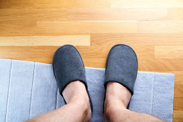 Male feet in gray hotel slippers, top view.Clear warm domestic sandal or sneakers. Bed shoes accessory footwear.