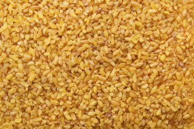 Top view of uncooked organic bulgur grains.Bulgur Wheat Background.