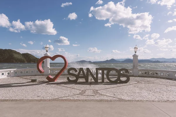Santos, Brazil - August 10, 2022: I love the city of Santos. Red heart. Sculpture. Tourist attraction to take pictures by the sea, including the city landmark wall.