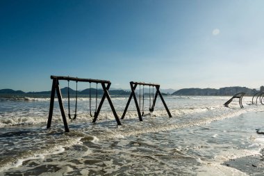 City of Santos, Brazil. High tide invades the sand strip and the children's playground.