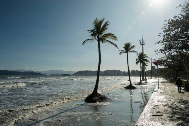 City of Santos, Brazil. High tide invades the strip of sand to the sidewalk by the sea.