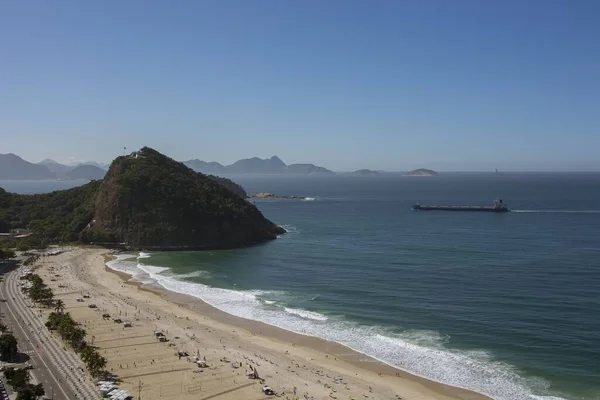Rio de janeiro Brazil. Aerial view of Leme beach and Atlantica avenue on a sunny morning. A bulk carrier is approaching towards the port.