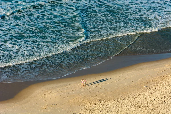 Couple running on Copacabana beach in the morning in Rio de Janeiro, Brazil