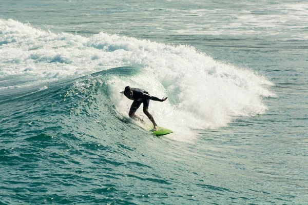 Ipanema Beach, Rio de Janeiro, Brazil. May 25, 2022: Surfer riding a wave at the beach in Rio de Janeiro, Brazil.