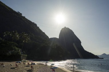 Rio de Janeiro, Brazil. Sugarloaf Mountain and Red Beach. Sun shining in the morning sky.