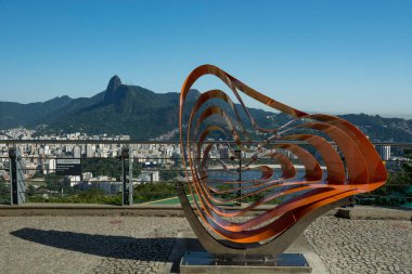 Rio de janeiro Brazil. May 24, 2022: Aerial view of Urca Hill. Sculpture symbol of the park and Sugar Loaf cable car. In the background the mountains and Christ.