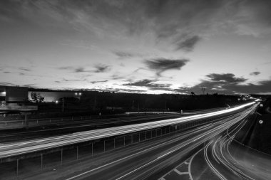 Traffic lights on the freeway at sunset. Long exposure. D. Pedro I highway, Atibaia, Brazil. Black and white image. 