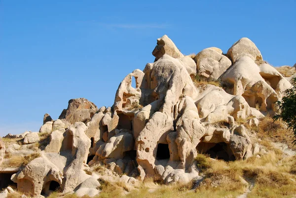 Cappadocia, Turkey.  Caves carved into the stone on a sunny day and blue sky.