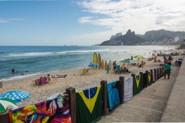 Ipanema Beach, Rio de Janeiro, Brazil. May 25, 2022: Bathers enjoying the sunny day. Two Brothers Hill in the background.