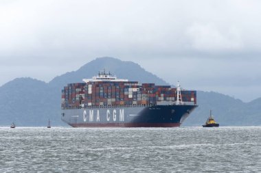 Konteyner gemisi CMA CGM Yelkenlisi bulutlu bir günde liman kanalına girdi. Santos şehri, Brezilya. 24 Ekim 2022. 