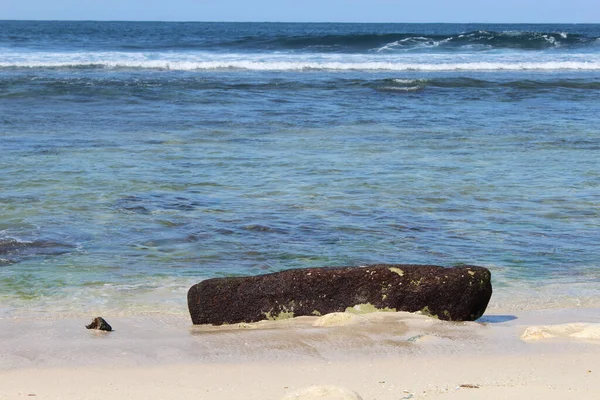 Black stone at the sea side
