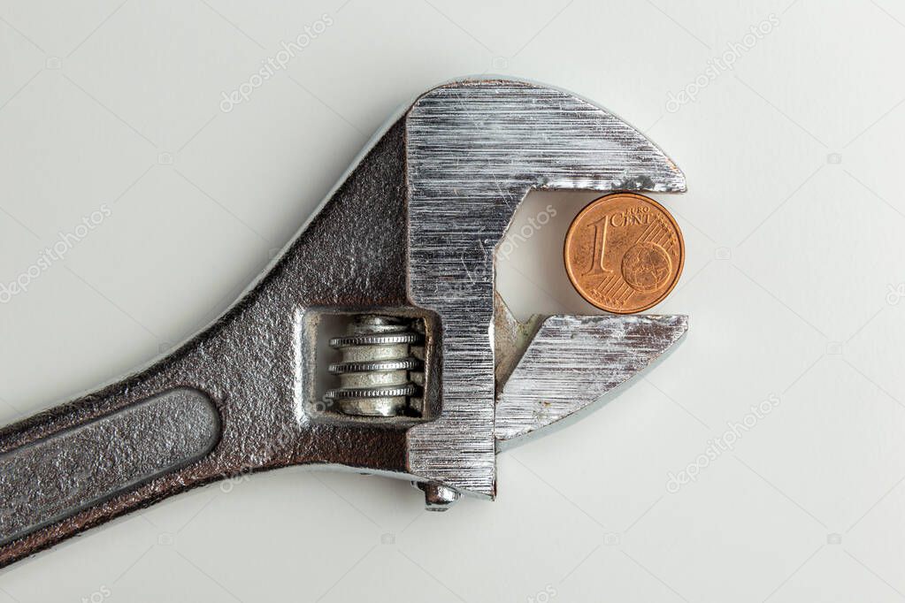 euro cent clamped in a adjustable wrench