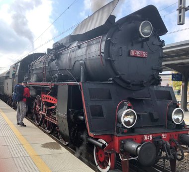 Vintage steam train with Ol49 engine waits for departure from Poznan Main Station, PL