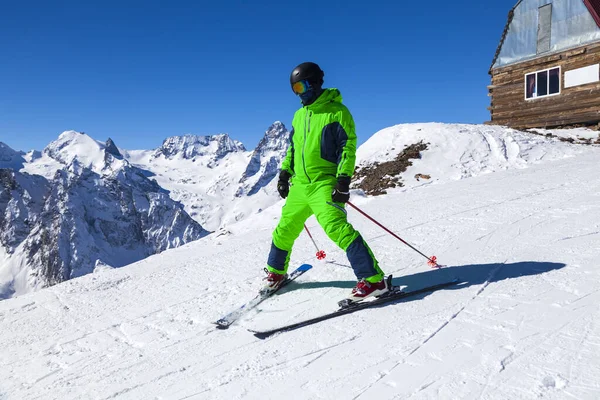 Opening of a ski resort, a young man on skis against the backdrop of mountains. Aerial view