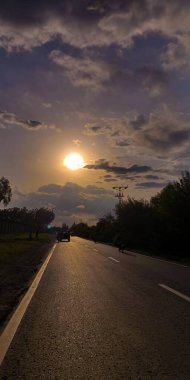 Straight road and clouds