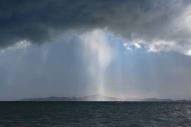 stormy weather dark clouds and light in the sea of pattaya
