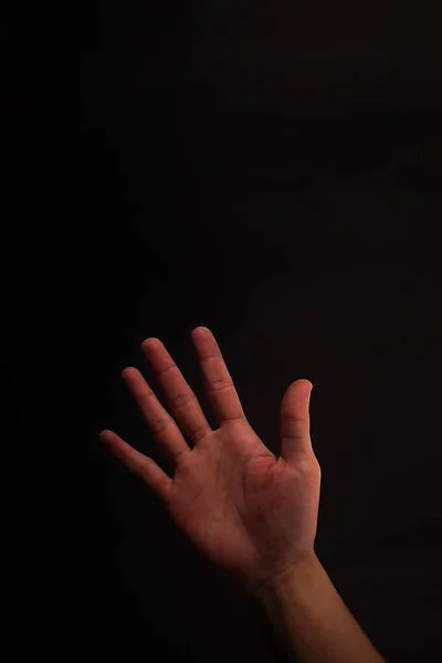 5 finger hand on black background