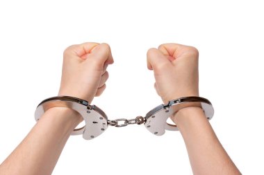 Woman's hands are clenched into fists, in handcuffs. Isolated on white background