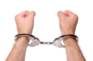 Men's hands are clenched into fists, in handcuffs. Isolated on white background