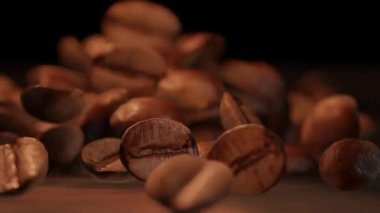 Coffee beans are falling to a wooden table (3D Rendering)
