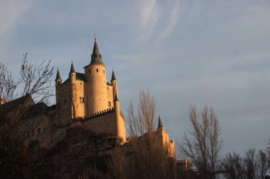 View of the Alcazar of Segovia at sunset. This fortress castle inspired the castles of Disney and the movie Hotel Transylvania.